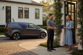 Professional courier making a same-day delivery at a modern home or business in Charleston