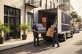 Professional movers loading furniture and boxes from a one-bedroom apartment into a moving truck in Charleston